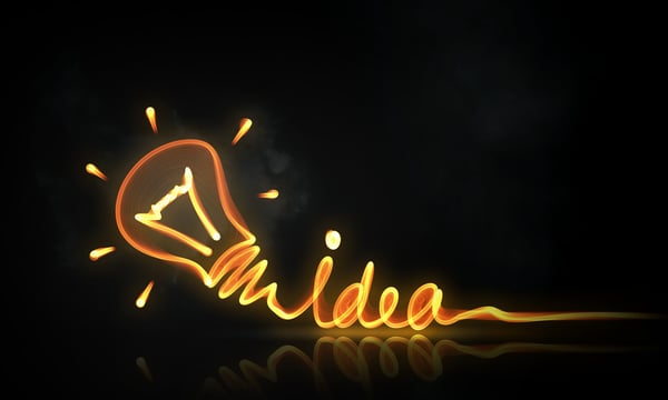 Idea concept with glowing bulb symbol on dark background
